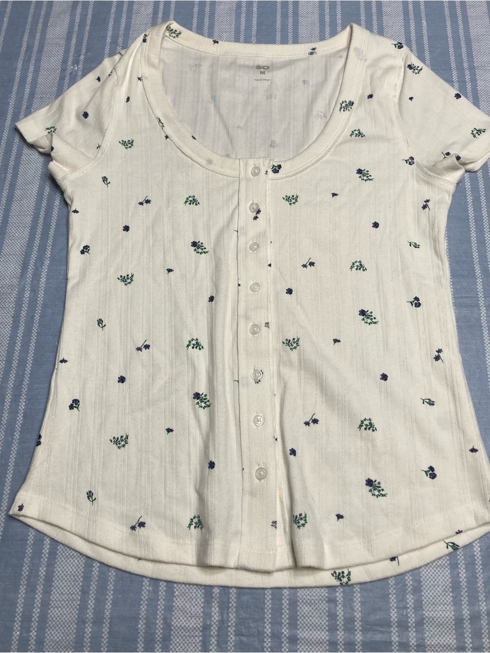 SO Junior off-white top with blue flowers.